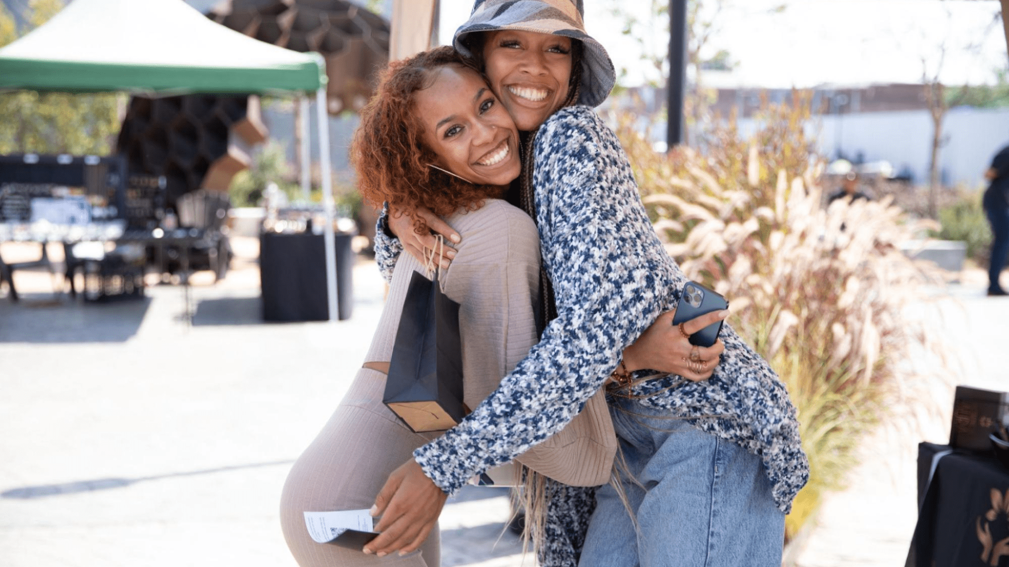 Two event guests hug and smile